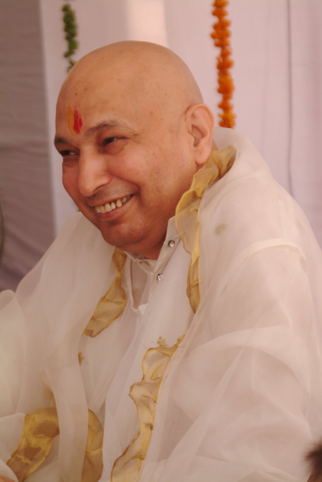Guruji smiling during a gathering